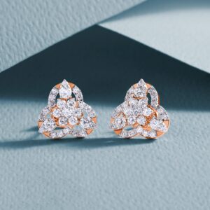 Luxurious diamond earrings with an intricate design on a textured background.